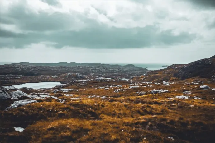 Rust-coloured moorland and lochans running to the sea